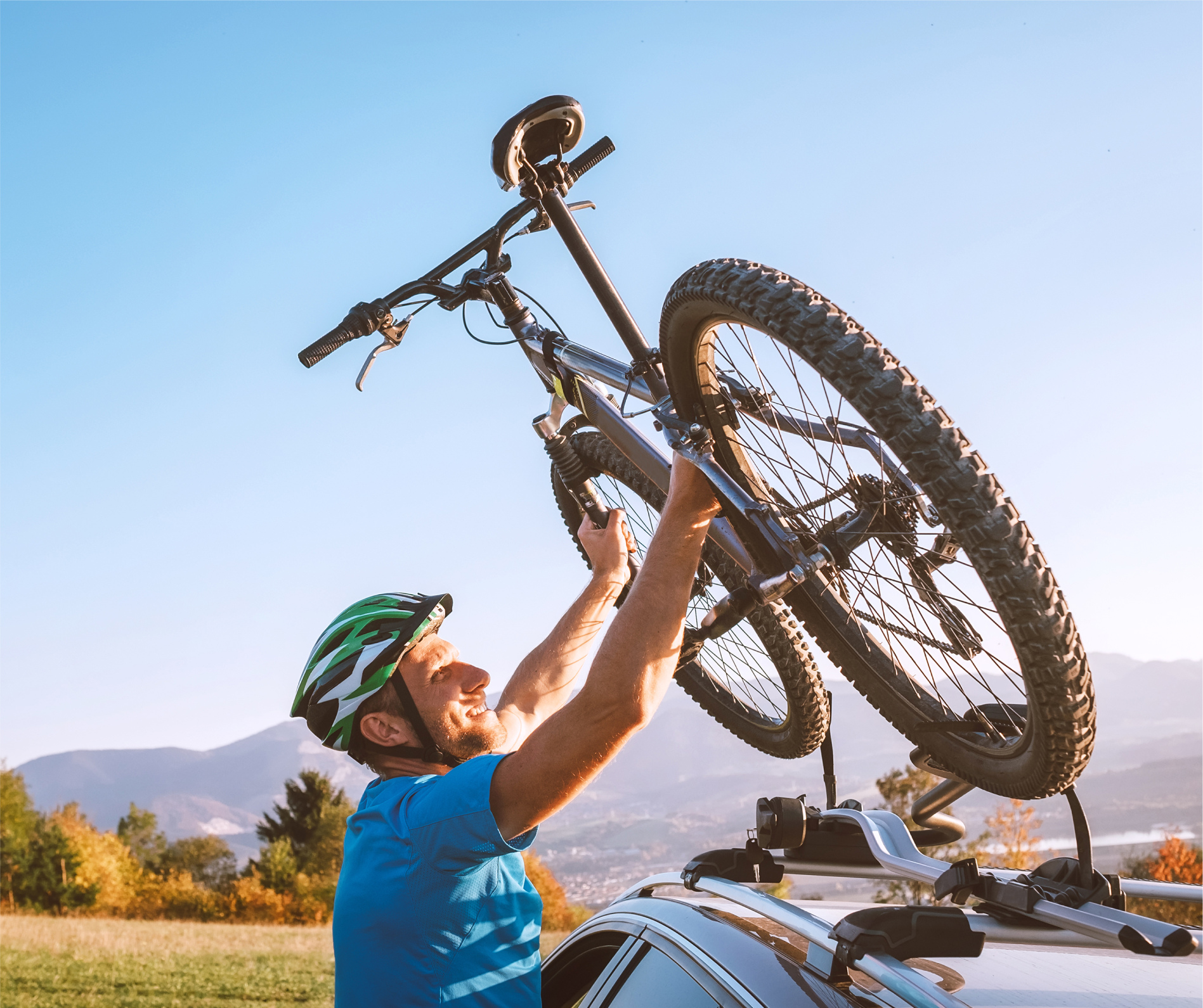 Person loading bike onto car rack