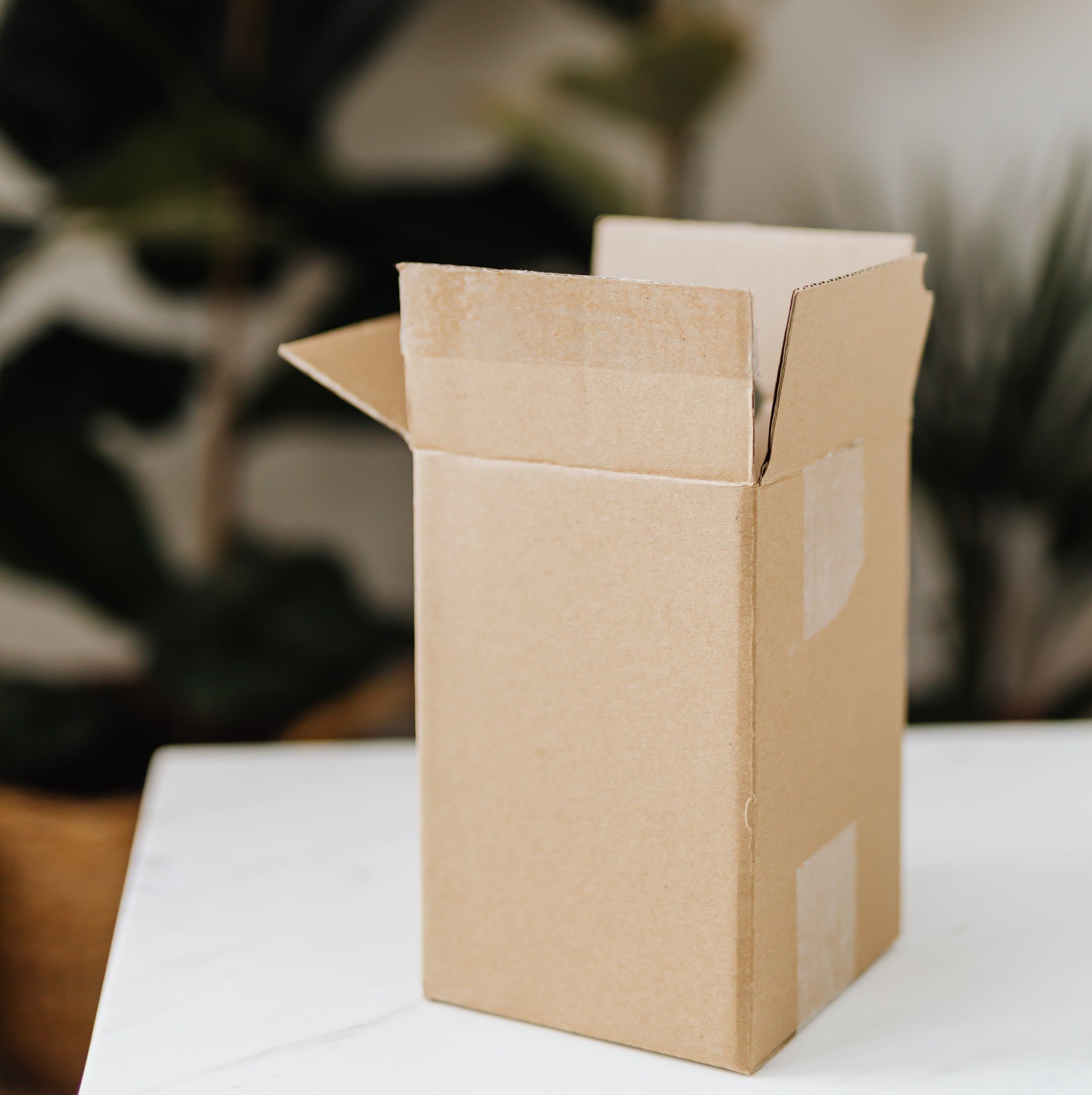 An opened cardboard box on a table.