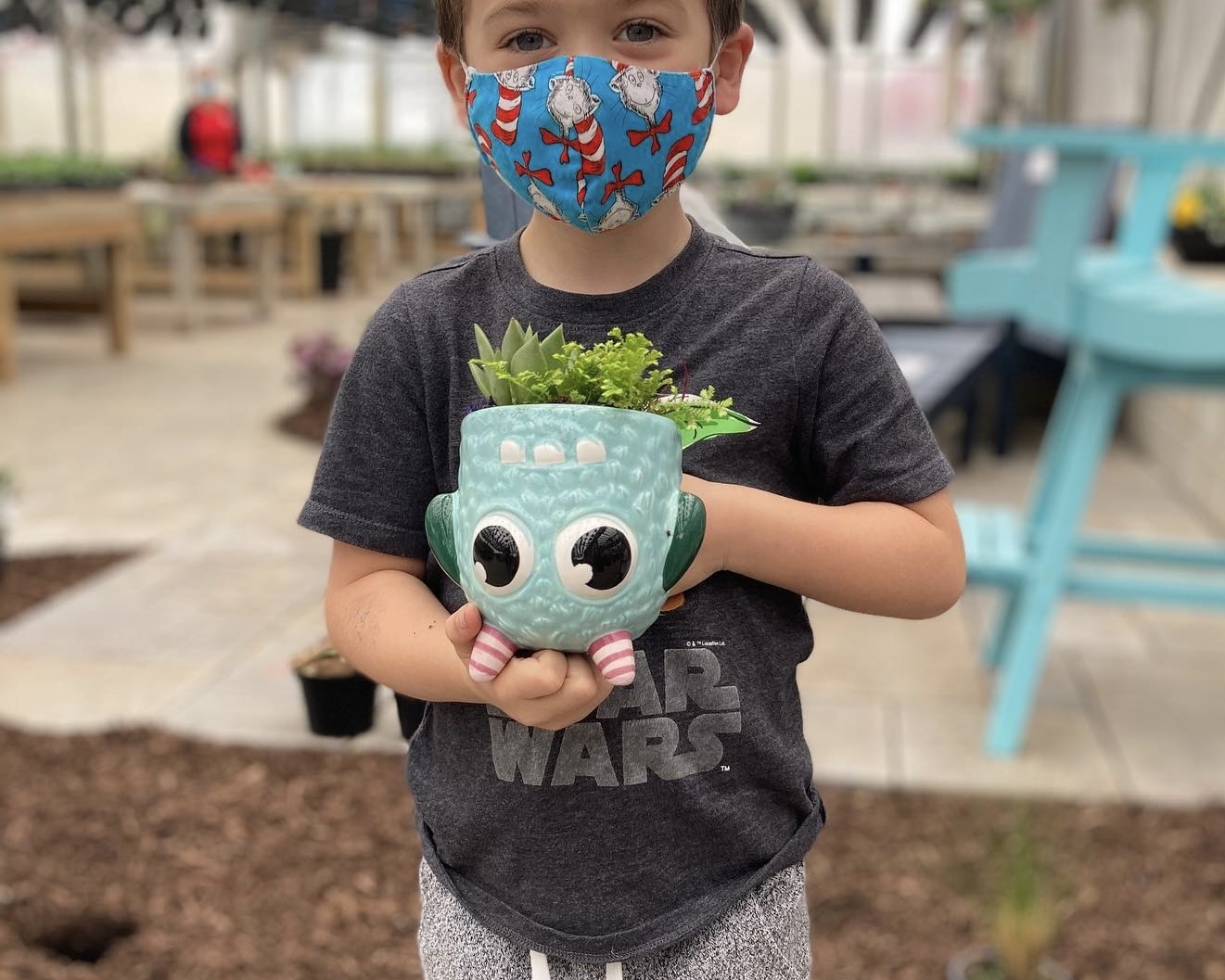 Young boy holding his plant.