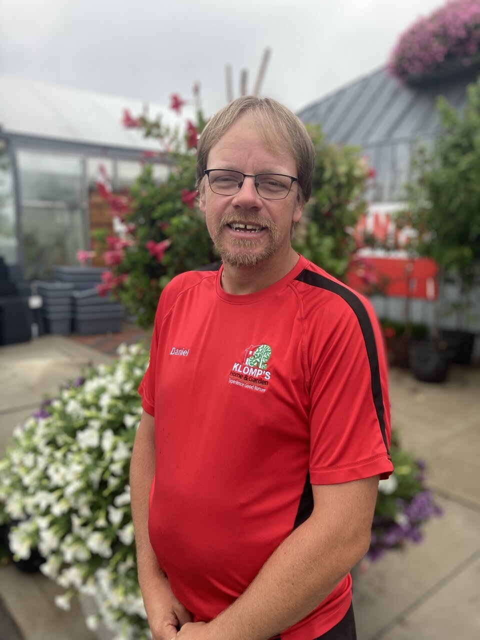 The General Manager, Daniel Klomp, wearing a red, green and black Klomp’s t-shirt. 