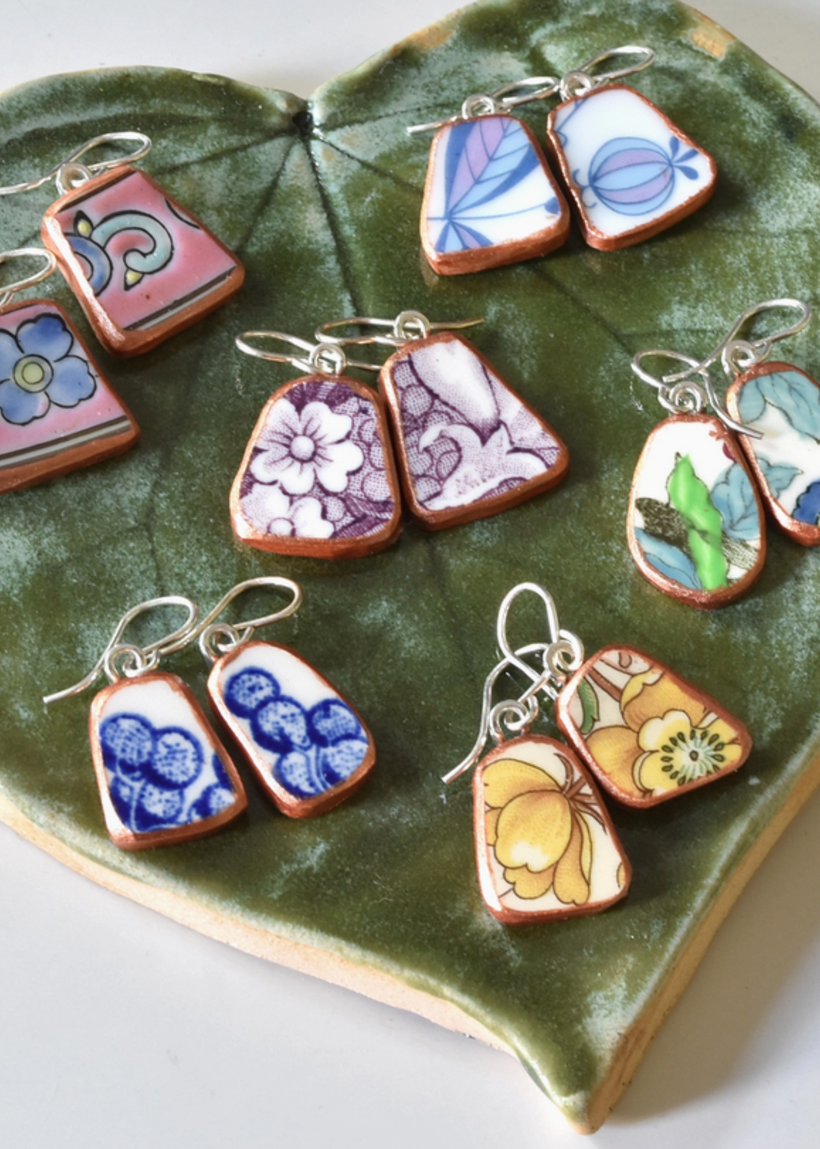 the broken plate co The Broken Plate Dangle Earring  Shard Shape Mixed Patterns Rose Gold Porcelain Paint
