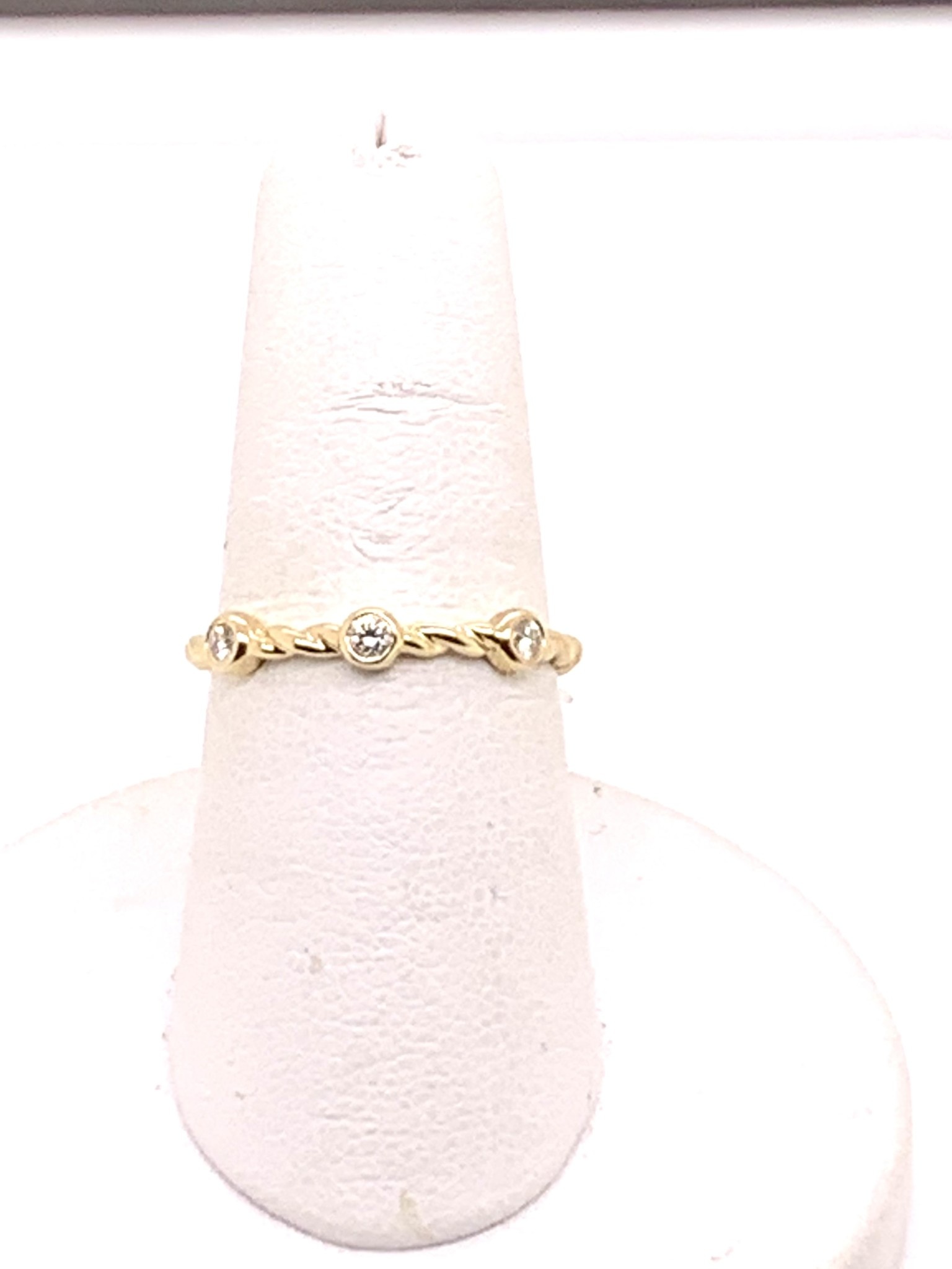 Yellow gold 0.10ct diamond three stone twisted wedding band