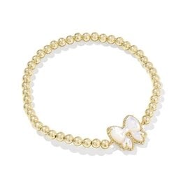 KENDRA SCOTT DESIGN Haley Bow Gold Stretch Bracelet in Ivory Mother-of-Pearl
