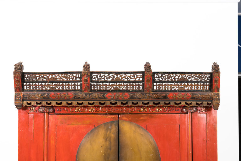 Red Chinoiserie armoire made for the English market. Decorative crown, 1880