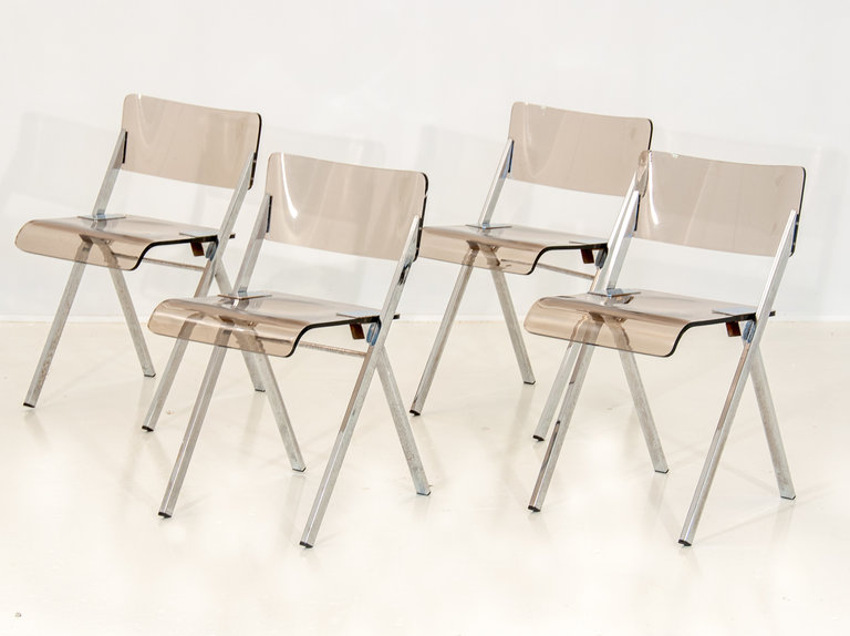 Set of four lucite folding chairs