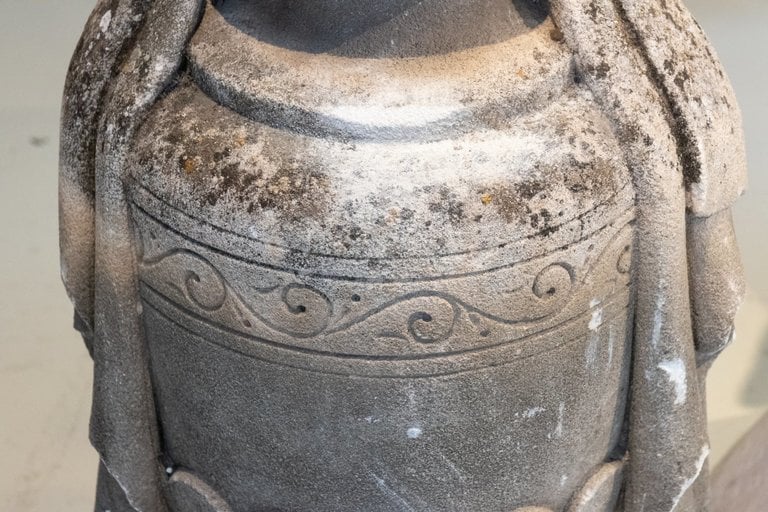 Stone carving on flamed urn
