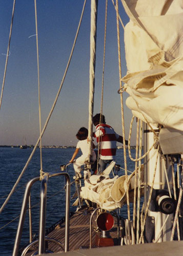 Michelle Stevens and her father on their sailboat looking towards the horiizon