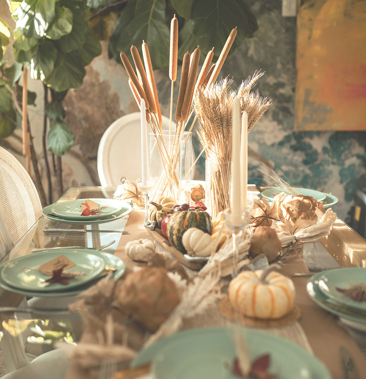 a Thanksgiving tablescape with candles, gourds and place settings