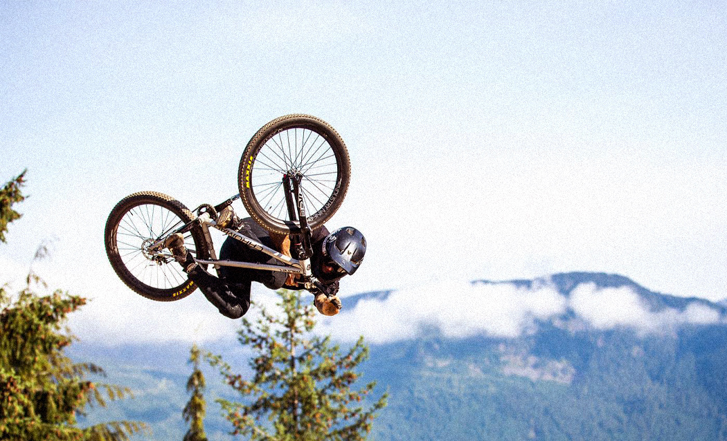 Photo of a mountain biker doing an inverted table-top.