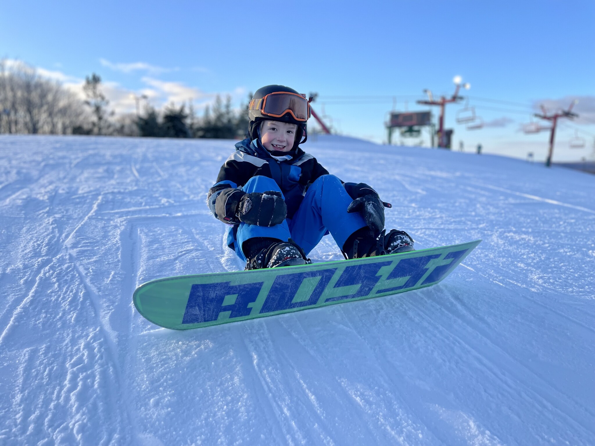 Young snowboarder riding on snow