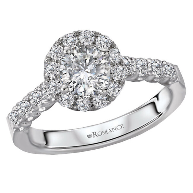 Romance This round halo engagement ring showcases a shank lined with sparkling diamonds set in high polished 14kt white gold. (D 1 carat total weight inlcuding a 1/2 carat round center diamond)