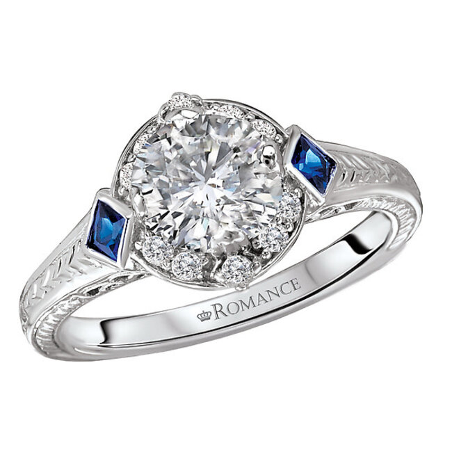 Romance This vintage style 14kt white gold engagement ring has engraved designs along the shank and two cushion shaped sapphires on either side of a setting that will accommodate a 6.5mm round diamond. (D 1/8 and S 1/6  carat total weight)
