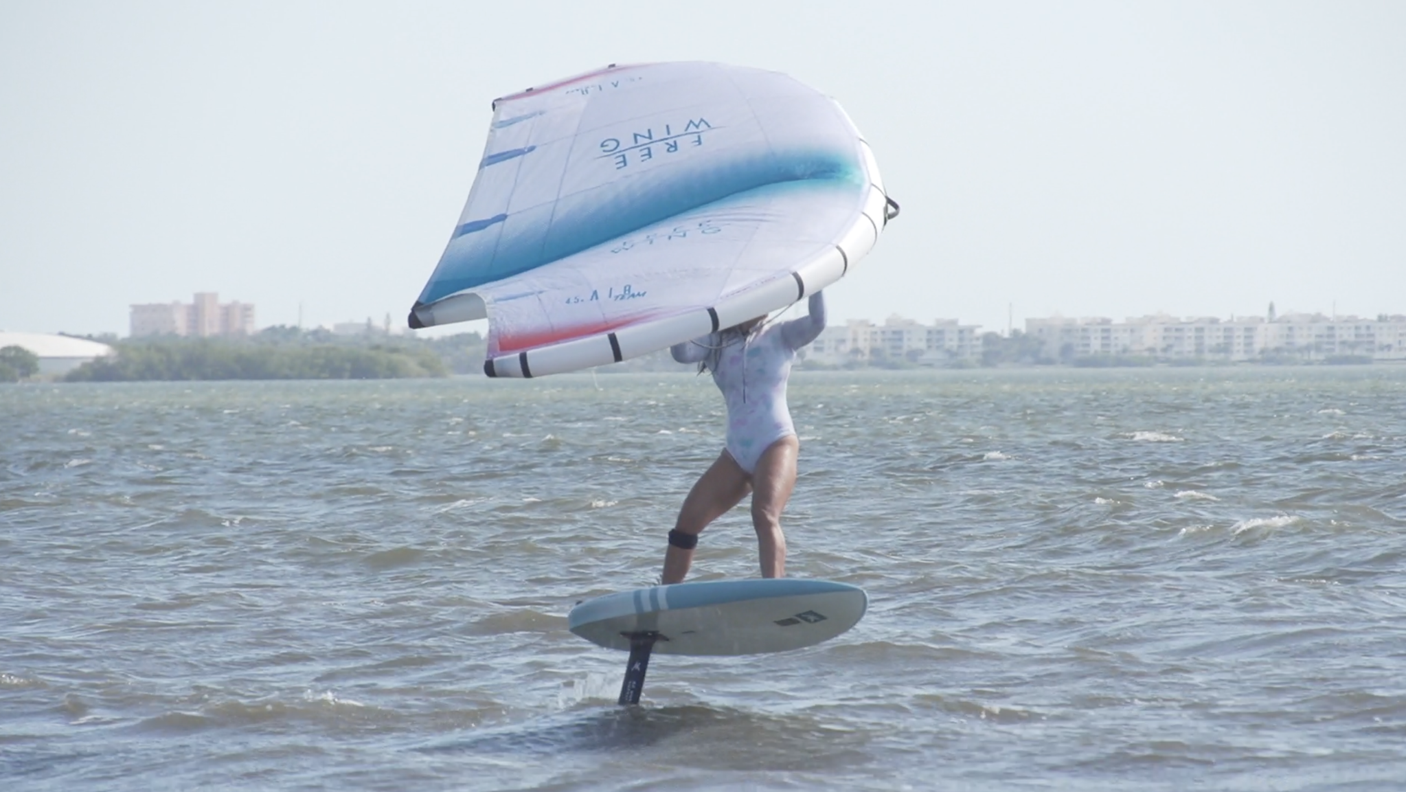 A girl wing foiling Cocoa Beach