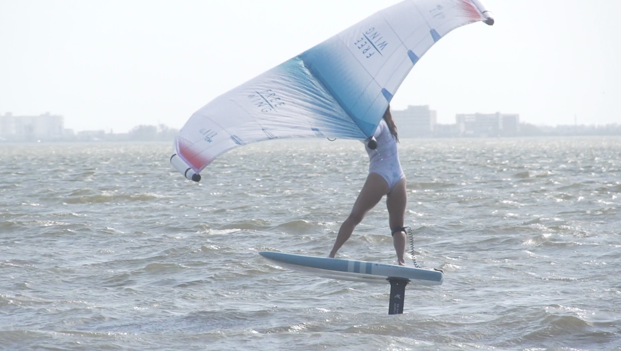 Young woman wing foiling cocoa beach