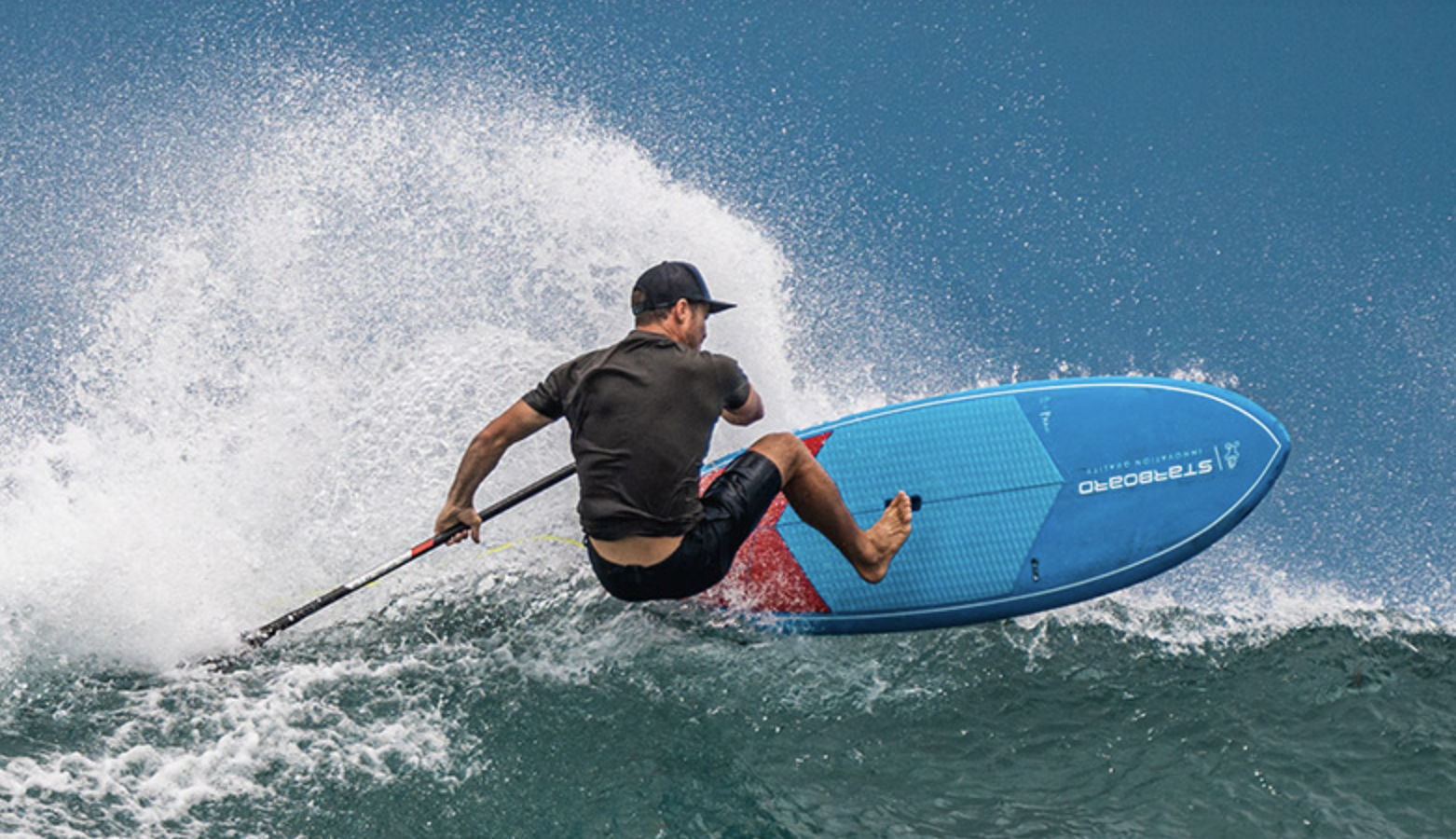 A paddle boarder surfing the ocean