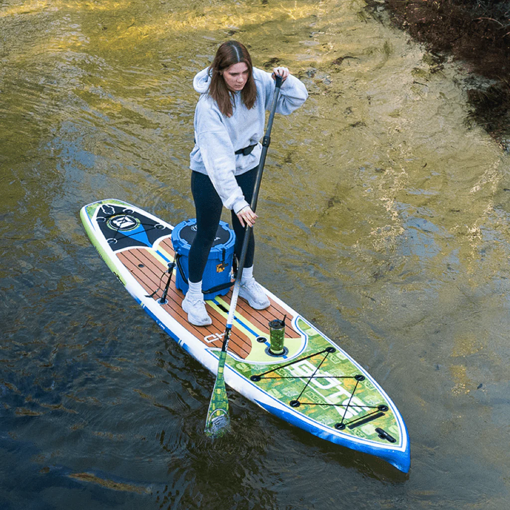 A woman is having a calm and quite ride with the BOTE 10'6 HD GATORSHELL paddle board.