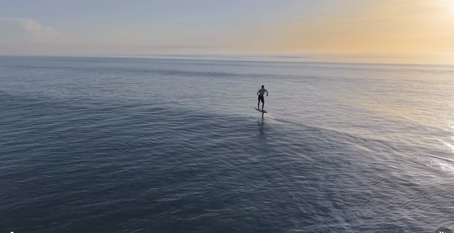Nicholas Reeser riding an efoil in Cocoa beach during sunset