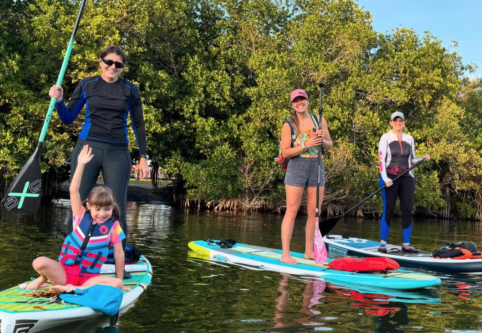 1. Family and group enjoying a guided paddleboard tour on calm mangrove waterways in Cocoa Beach, Florida.