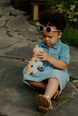 Pebble Steggy Dino Rattle Teal Organic