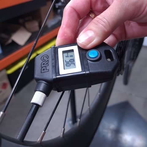 Checking tyre pressure with digital gauge