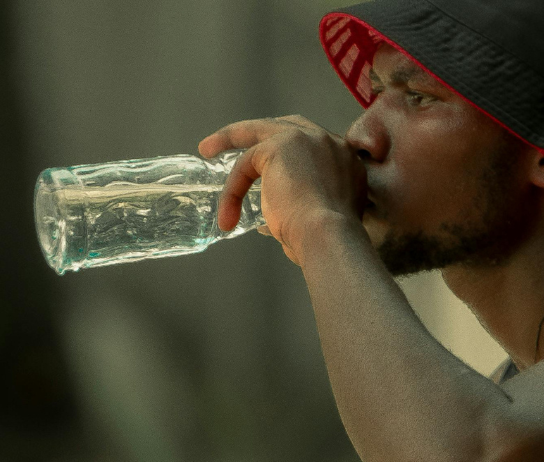 Site worker drinking from waterbottle