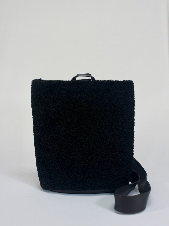 PRIMECUT: BLACK SHEARLING SLING BAG