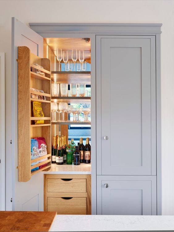 Light blue cabinetry conceals a hidden pantry unit.