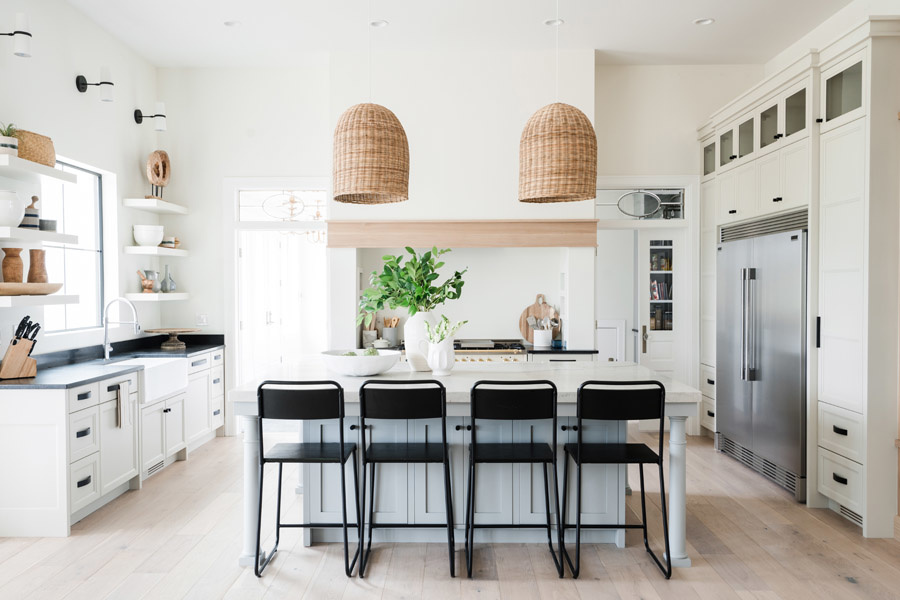 Bright white kitchen with large island and overhead lights