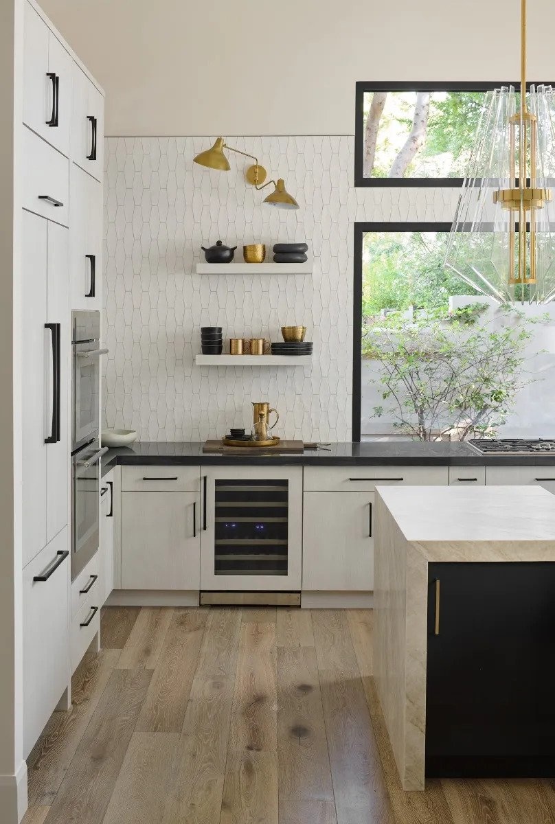 Bright white kitchen with black pulls and appliance pulls