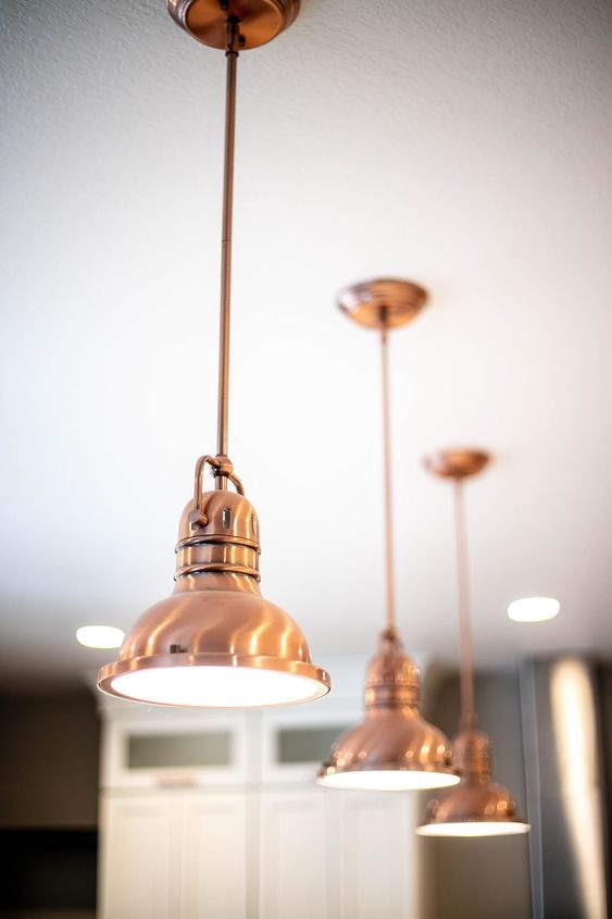 Copper pendant lights hanging in kitchen