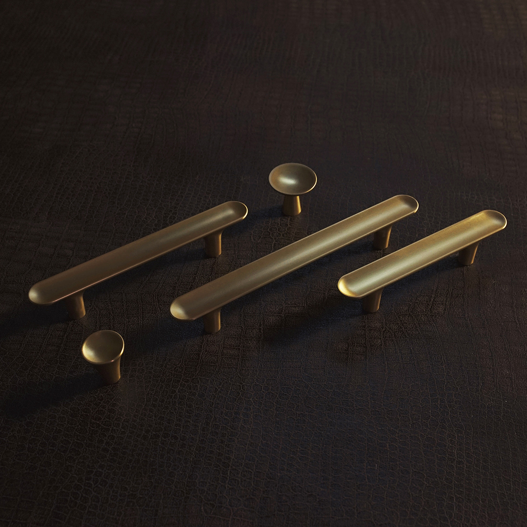Mod century modern gold handles on a black leather background