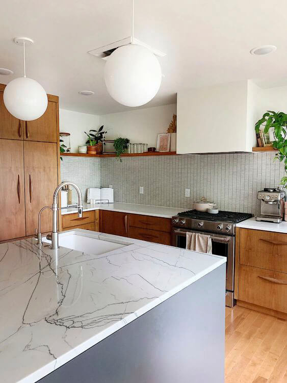 Mid-century modern home with large round pendant lights and wood grain cabinetry