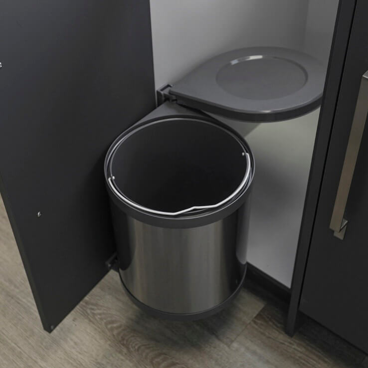Grey trash can mounted inside cabinet