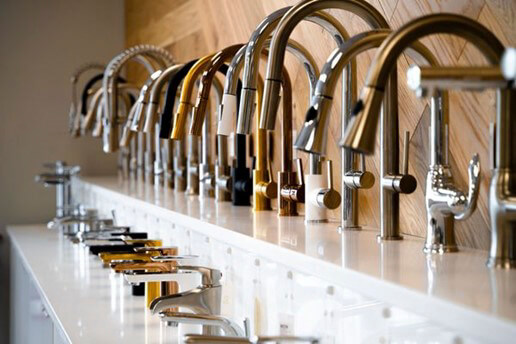 Variety of faucets in different colours all in a line