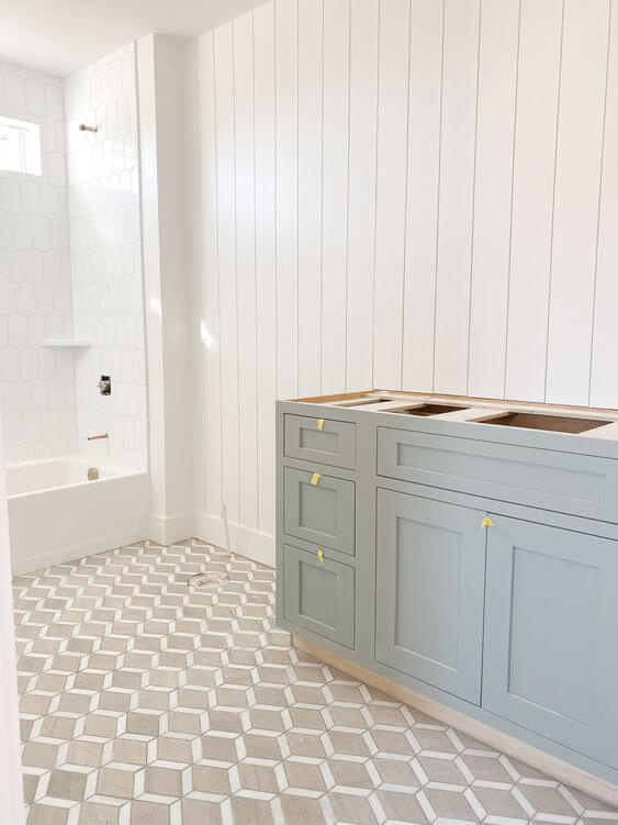 Powder blue cabinets being installed in a bathroom renovation