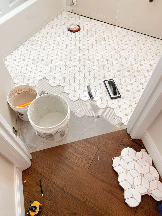 Hexagon tiles being installed in bathroom