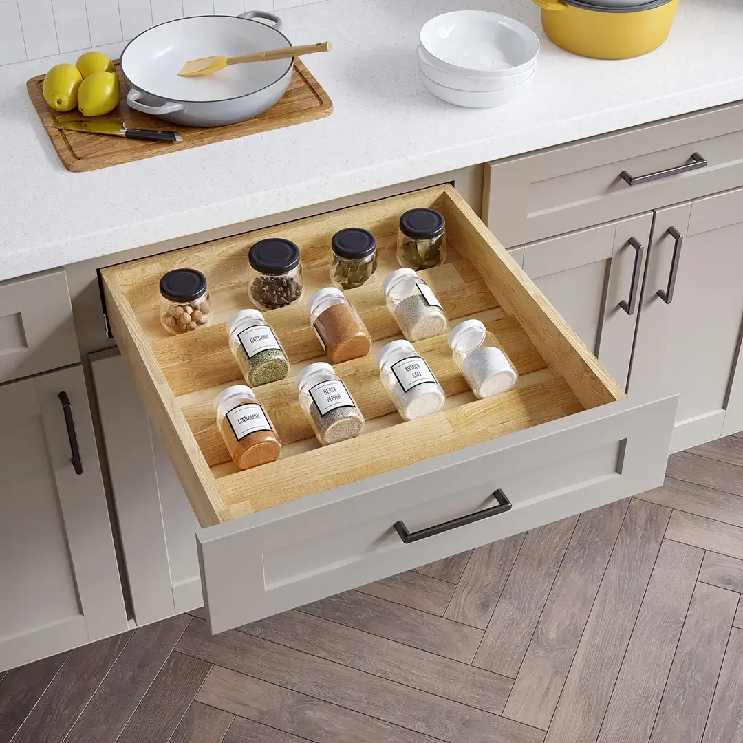 Drawer insert spice rack with spices laying neatly on shelves