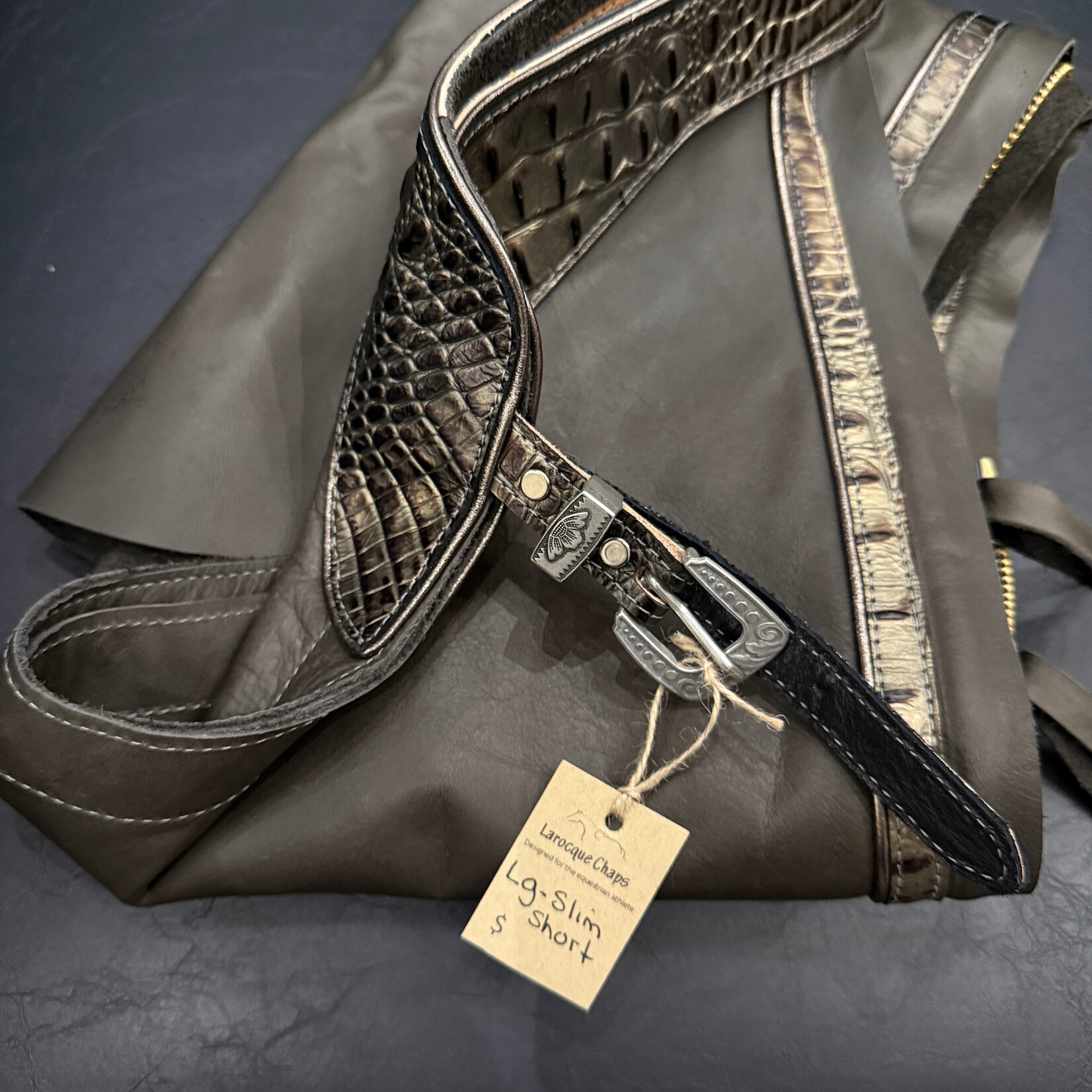 Larocque Chaps Larocque Custom Chaps, Dk Grey Aniline Leg, Hornback Black/Bronze Belt & Trim, Metallic Pewter Piped Belt & Leg, Silver Floral front Buckle, Silver Letters: RIDE, ready-made in stock size Lg Slim-Short