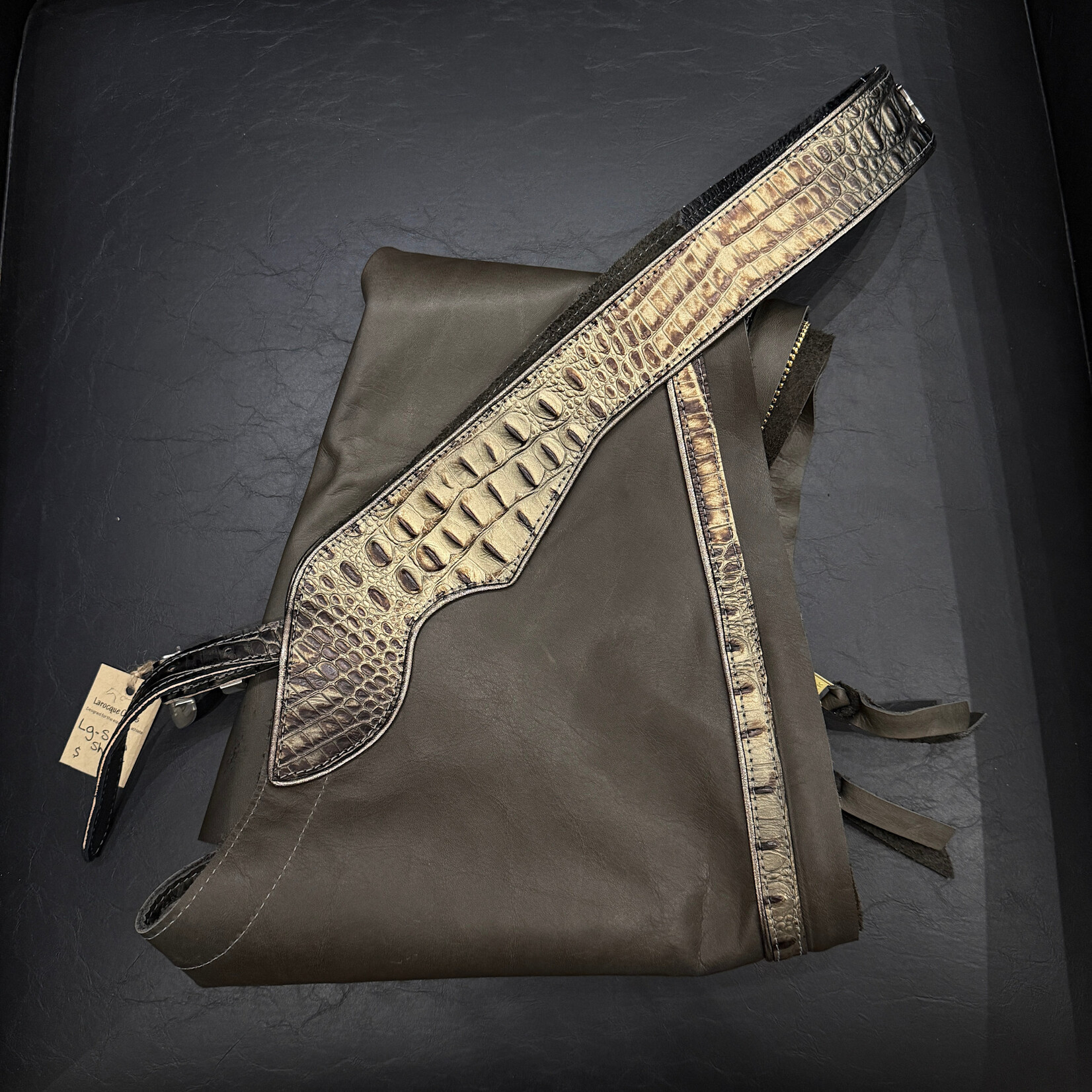 Larocque Chaps Larocque Custom Chaps, Dk Grey Aniline Leg, Hornback Black/Bronze Belt & Trim, Metallic Pewter Piped Belt & Leg, Silver Floral front Buckle, Silver Letters: RIDE, ready-made in stock size Lg Slim-Short