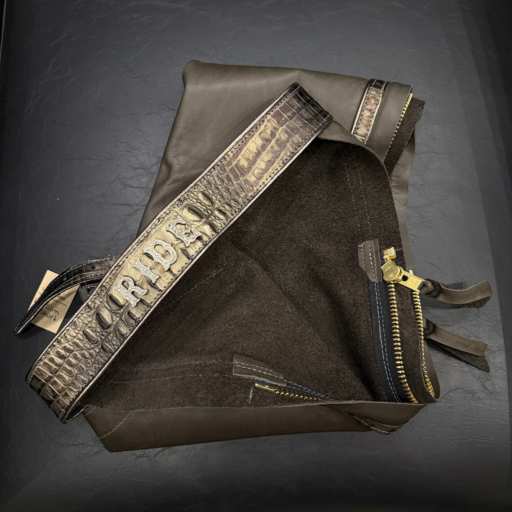 Larocque Chaps Larocque Custom Chaps, Dk Grey Aniline Leg, Hornback Black/Bronze Belt & Trim, Metallic Pewter Piped Belt & Leg, Silver Floral front Buckle, Silver Letters: RIDE, ready-made in stock size Lg Slim-Short
