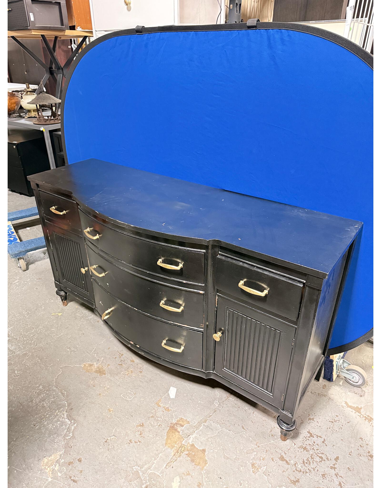 black, bow-front mahogany dresser or buffet with gold-toned hardware