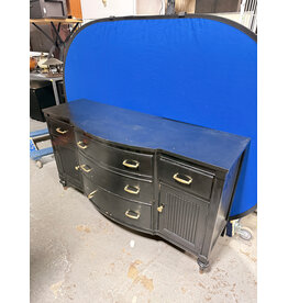 black, bow-front mahogany dresser or buffet with gold-toned hardware