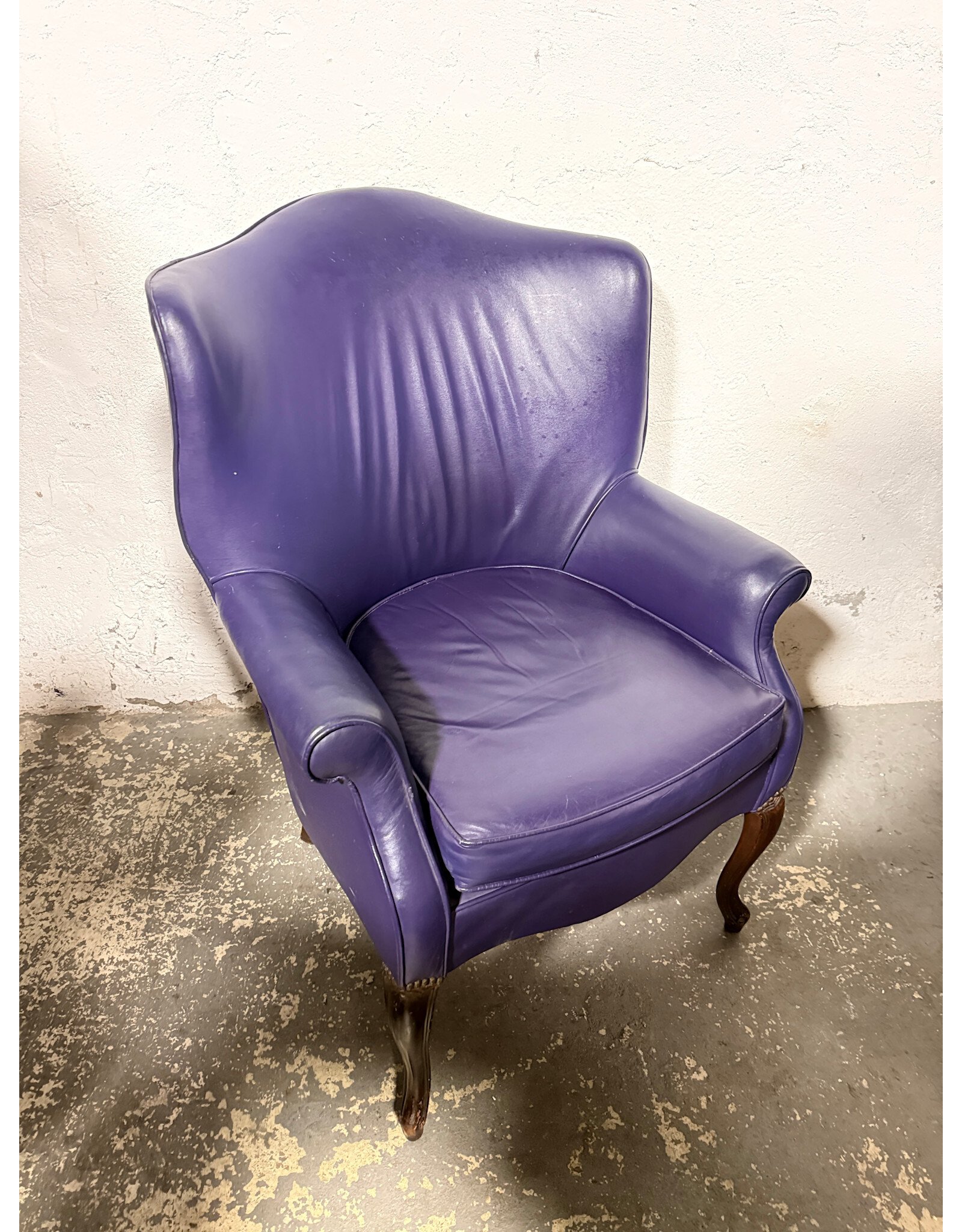 20th-century purple leather Queen Anne-style wingback chair with carved wood legs