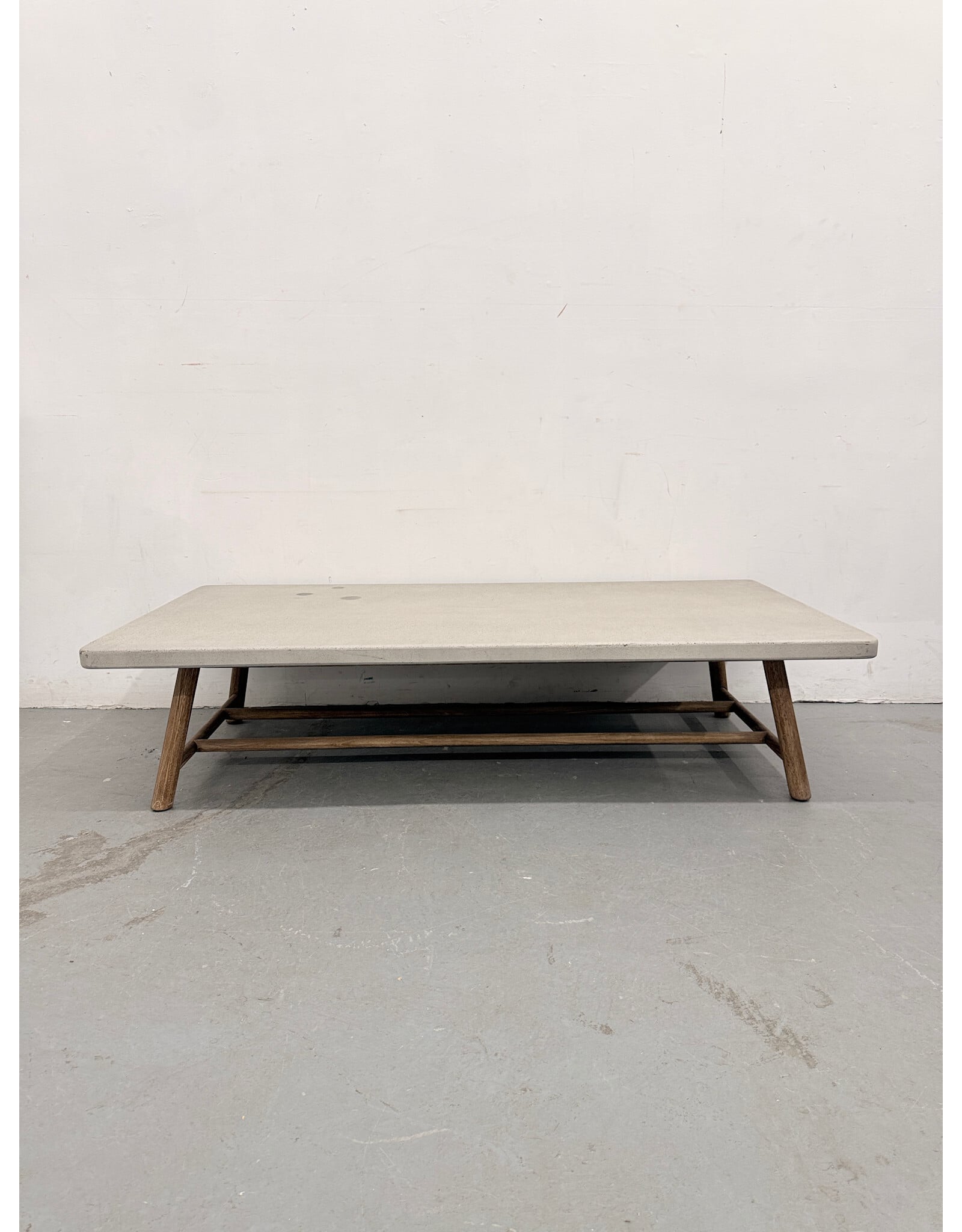 Crate & Barrel Fen Rectangular Outdoor Coffee Table with a concrete top and teak wood legs