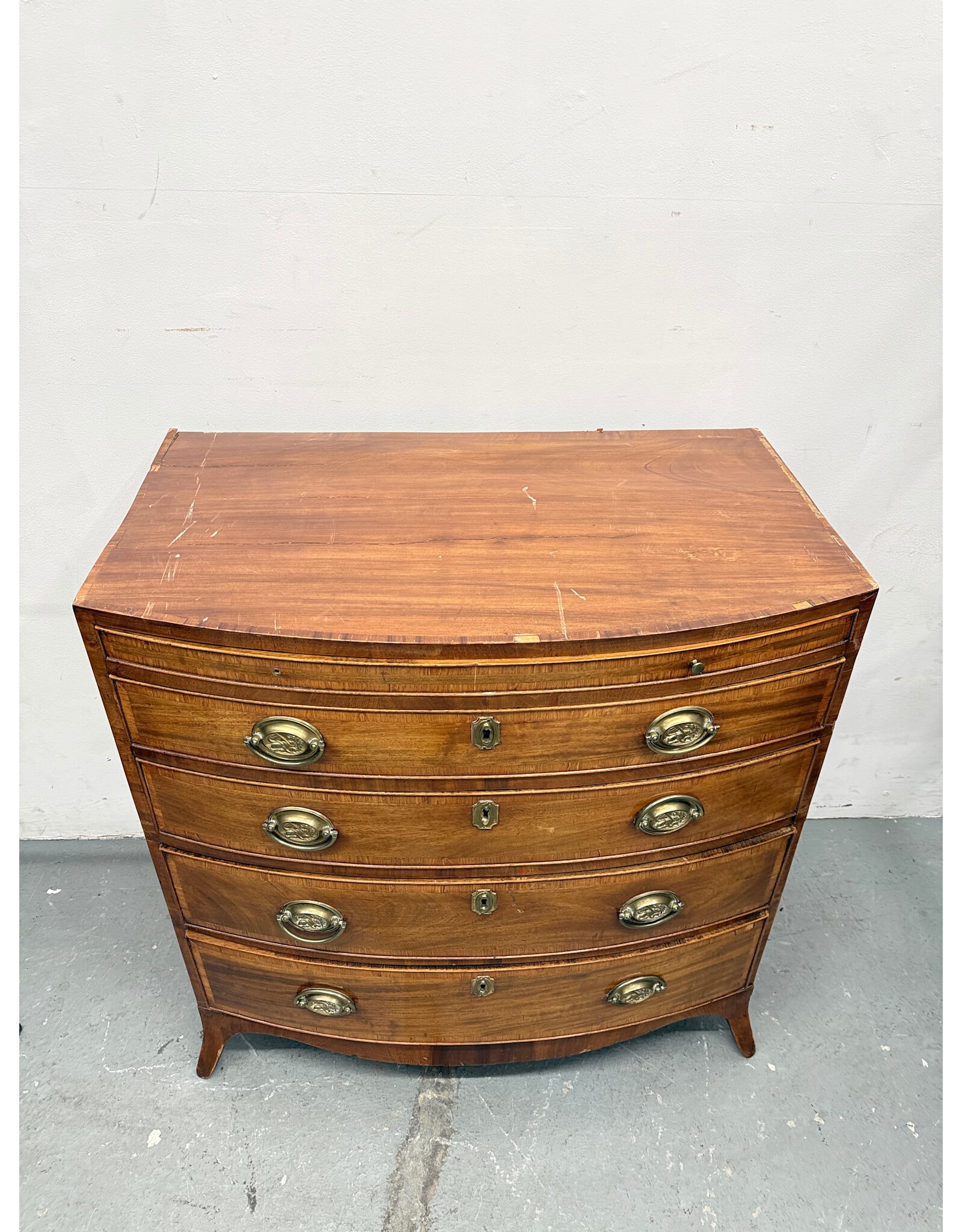 Antique Bow Front Chest with Brass Lion Drawer Pulls