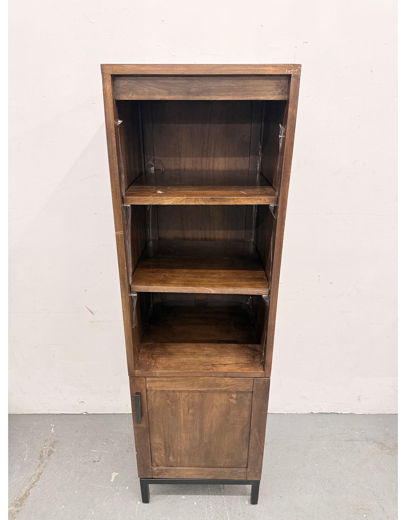 Crate & Barrel Wyatt Grey Media Storage Tower with three open shelves and a lower cabinet