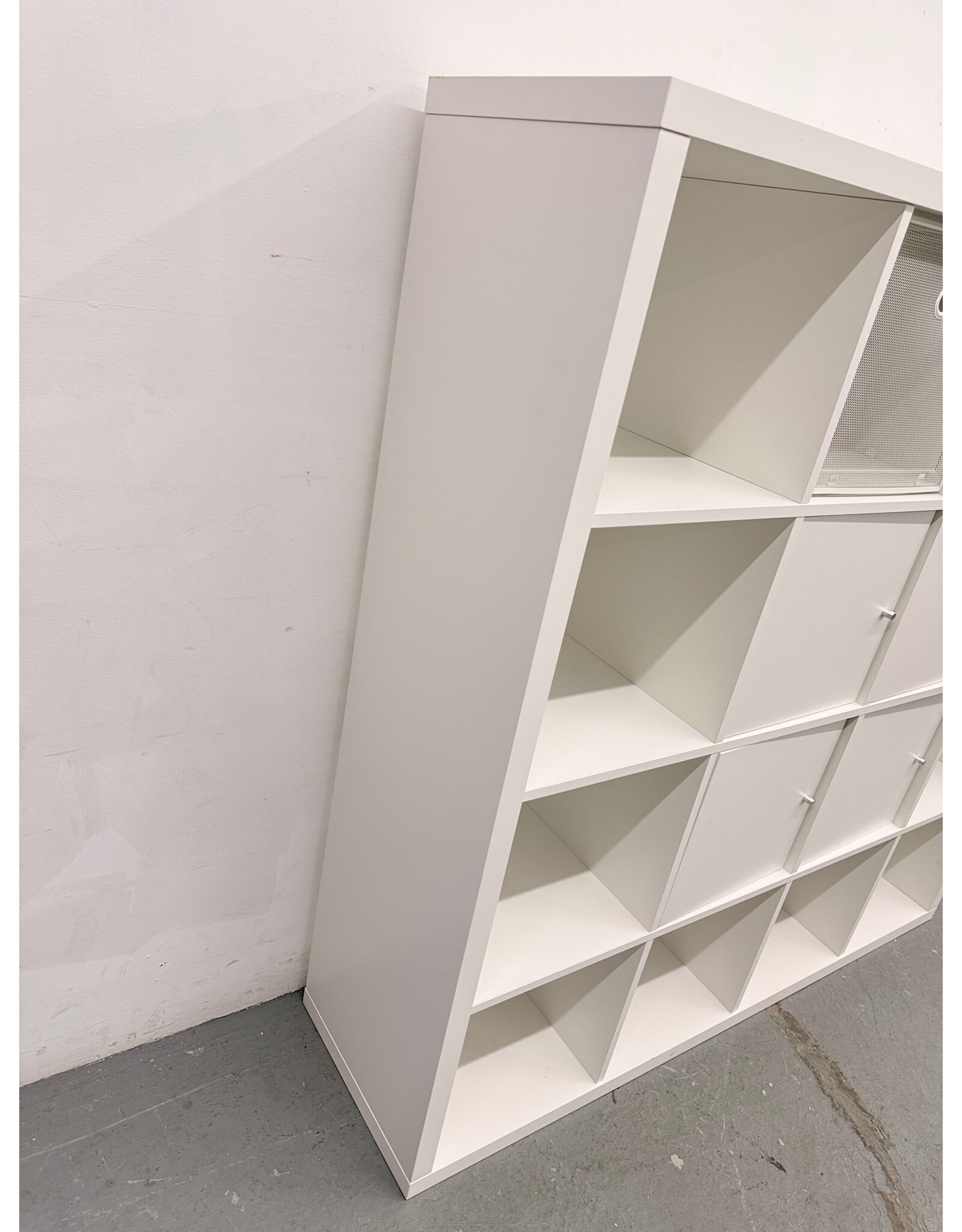 white IKEA KALLAX shelving unit with multiple storage
