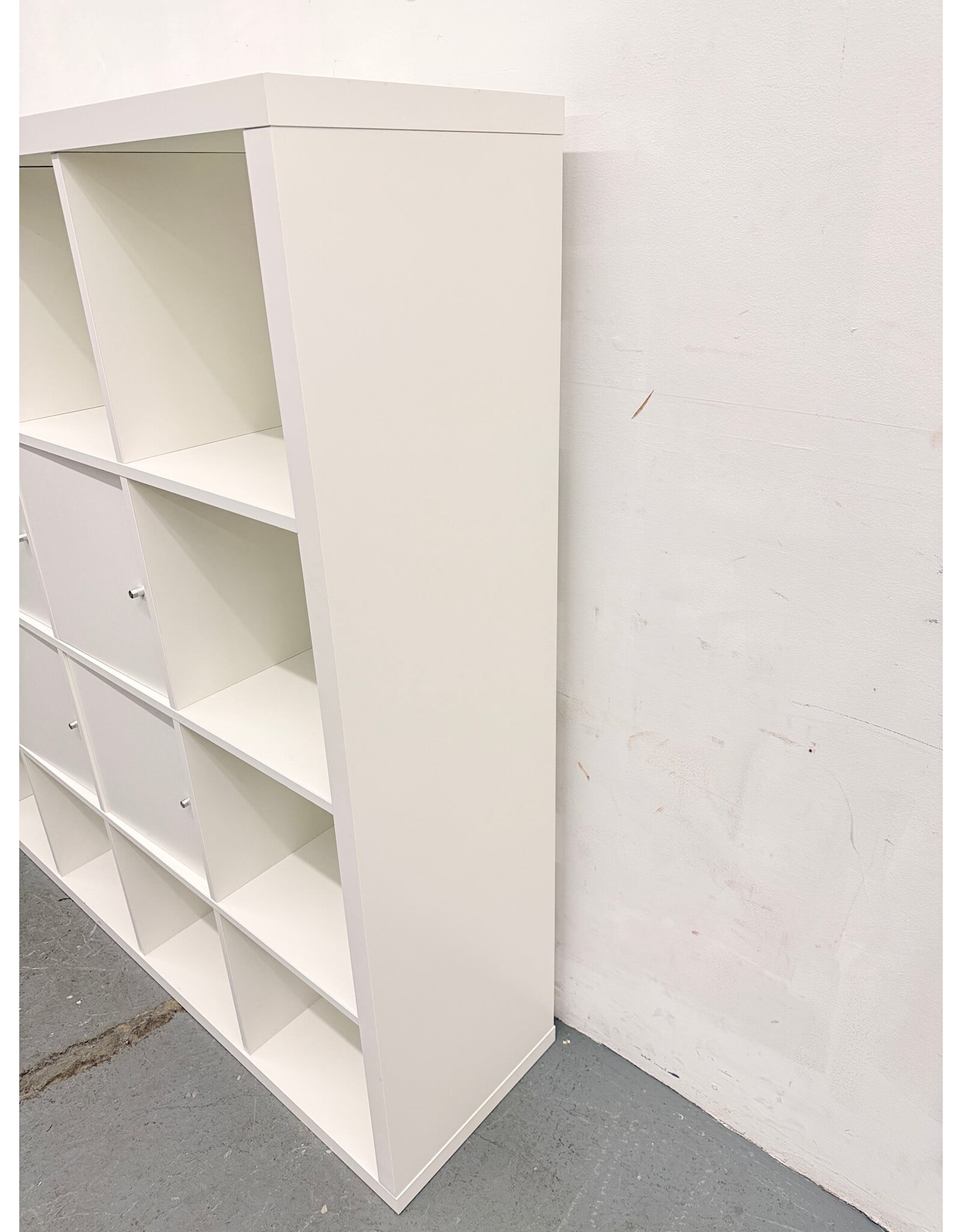 white IKEA KALLAX shelving unit with multiple storage