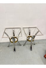 Mid-Century Modern accent tables featuring polished chrome arched legs and a brass ring stretcher