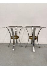 Mid-Century Modern accent tables featuring polished chrome arched legs and a brass ring stretcher